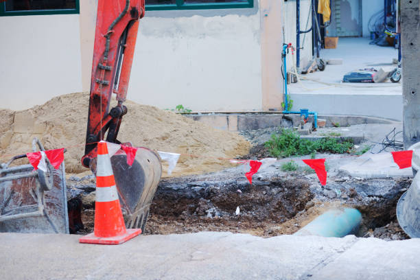 istock Small digger at construction site for restore sewer and canalization in Bangkok 1395748505