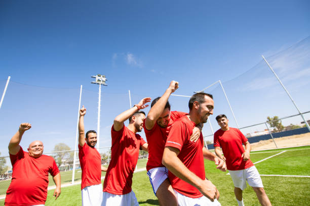 istock Soccer team celebrating victory 1395748572