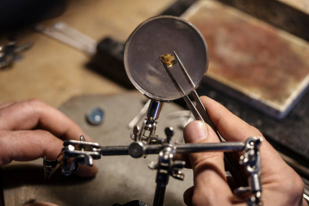 istock Jeweller examining a precious gem 1395749184