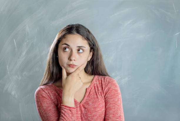 Young woman doubt emotion and gesture portrait in studio