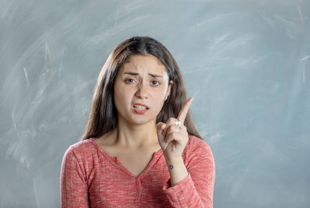 istock Young woman negative emotion and gesture portrait in studio 1395749305