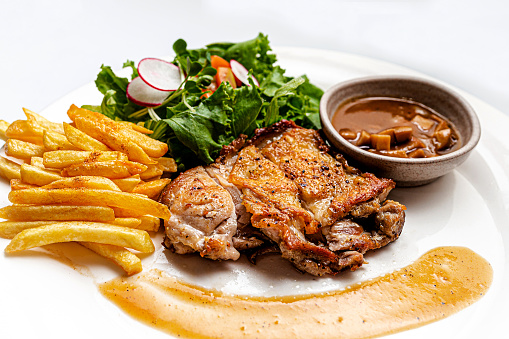 Juicy Seared Baked Chicken Breast Fine Dining Plate with Salad, French Fries, Mushroom Sauce