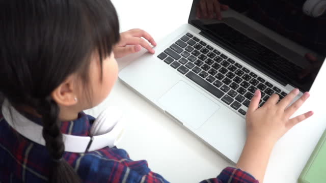kid typing keyboard when using laptop