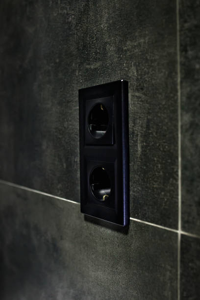 istock New black rosette on a ceramic tile of black color. Electrical outlet. Bathroom. 1395753608