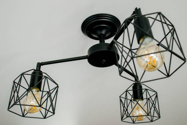 istock Geometric lamp hangs on a white ceiling. Modern, minimalist lamp that successfully complements the interior in loft style 1395753633