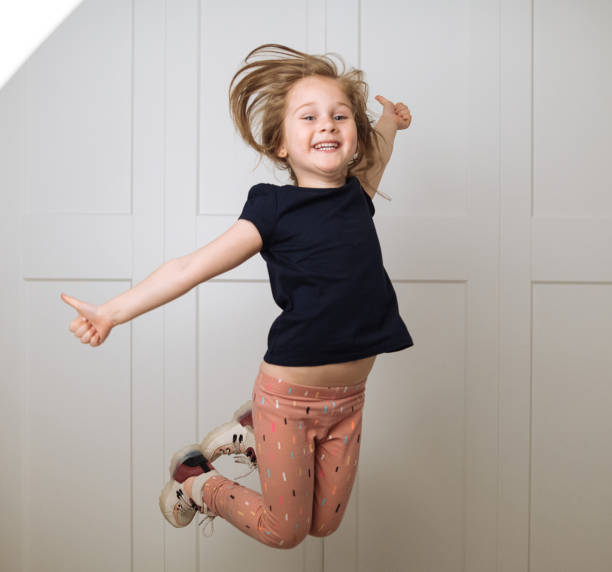istock Little girl jumping 1395753785