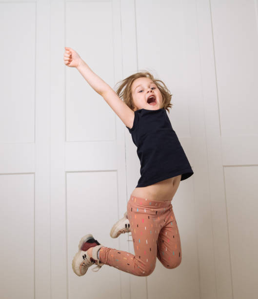 istock Little girl jumping 1395753790