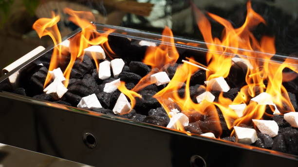istock Empty Barbecue Flaming Grill Close Up With Bright Flames And White firelighters burning 1395755228
