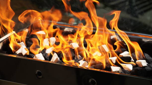 istock Empty Barbecue Flaming Grill Close Up With Bright Flames And White firelighters burning 1395755255