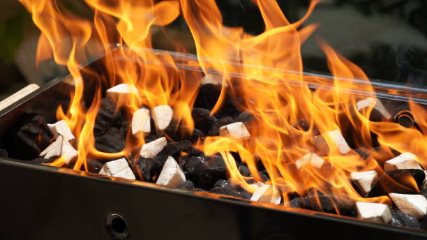istock Empty Barbecue Flaming Grill Close Up With Bright Flames And White firelighters burning 1395755273