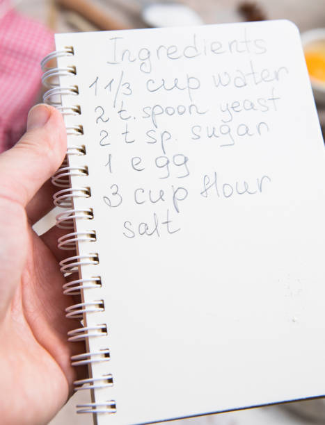 istock blank notebook for recipes in child hands. 1395756489