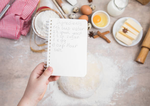 blank notebook for recipes in child hands.