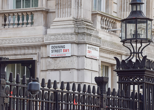 London, England; September 2019; Sign for Savile Row, City of Westminster, London, England with traditional architectural details in background.