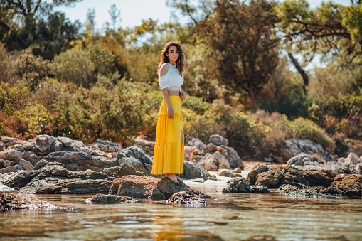 Beautiful Woman in Yellow Dress on the Beach