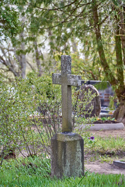 istock Ancient concrete cross in the cemetery 1395759726