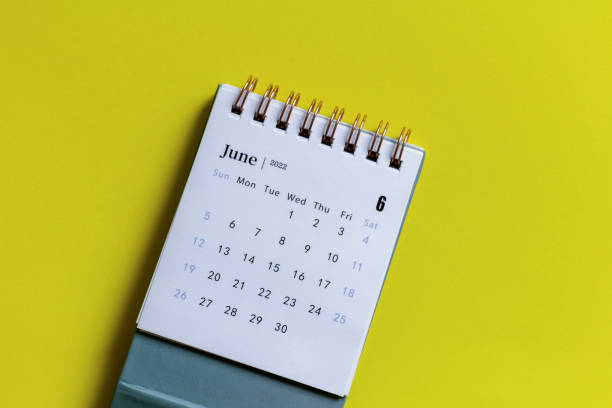 istock Desktop calendar for June 2022 on a yellow background. 1395760748