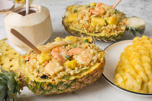Malaysian food - Thai pineapple fried rice with fresh coconut on the table
