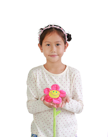 Portrait of young Asian girl child holding artificial flower giving for you isolated over white background.