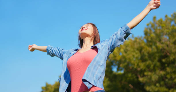 istock happy girl with arms up 1395762110