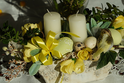 colorful table decorated with eggs, flowers, candles etc.
