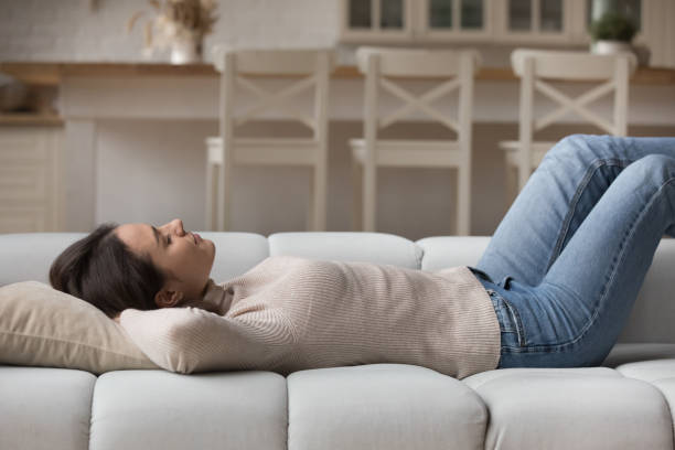 istock Young woman fell asleep on sofa at home 1395762561