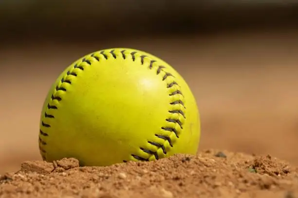 Softball in dirt on pitchers circle