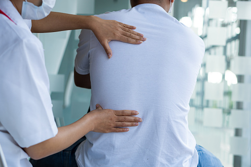 Chiropractic  Osteopathy treatment, Back pain relief. Physiotherapy for senior male patient Doctor consulting with patient Back problems Physical therapy concept