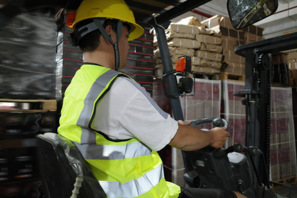 istock Workers drive forklifts in the warehouse 1395765769