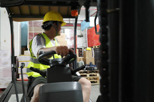 istock Workers drive forklifts in the warehouse 1395765791