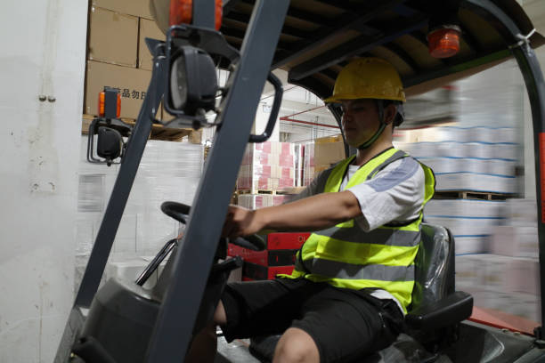 istock Workers drive forklifts in the warehouse 1395765825