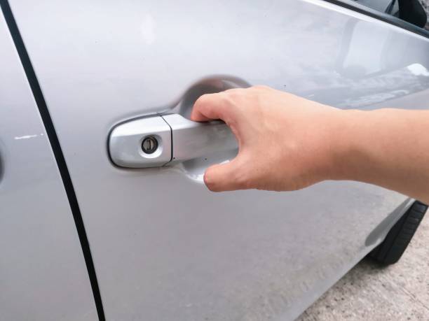istock man hand holding bronze car door 1395766039