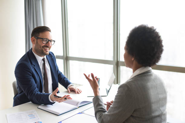 istock Smiling businessman discussing to a job candidate 1395766802