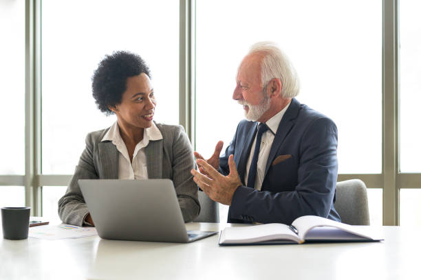 istock Smiling businesswoman talks to an experienced manager 1395766812