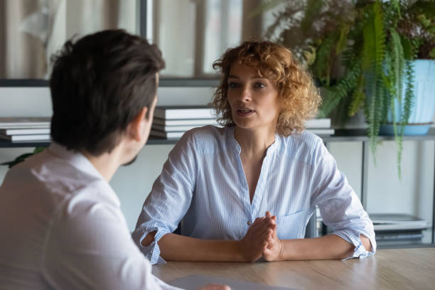 Two business coworkers, partners negotiating on project, deal Two business coworkers, partners negotiating on project, deal. Serious recruit HR manager, employer interviewing job candidate on meeting in office. Female boss, leader instructing employee grave stock pictures, royalty-free photos & images
