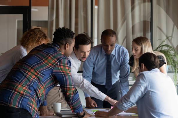 Busy diverse business team working on project together stock photo