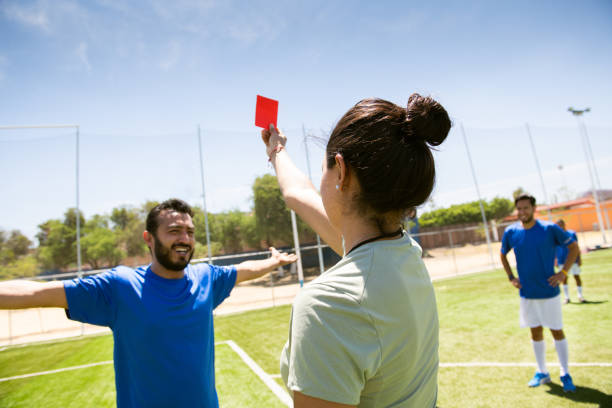 istock Female refree showing red card to soccer player 1395769990
