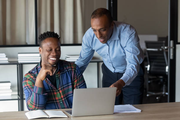 istock Happy African American employees watching video presentation on laptop 1395770067
