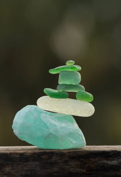 istock Tiny sea glass pebbles balancing on a rough apatite stone 1395772959