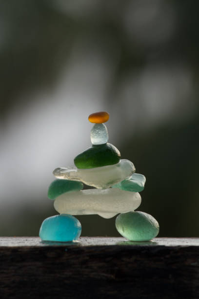istock Tiny sea glass pebbles of different colours balancing 1395772965