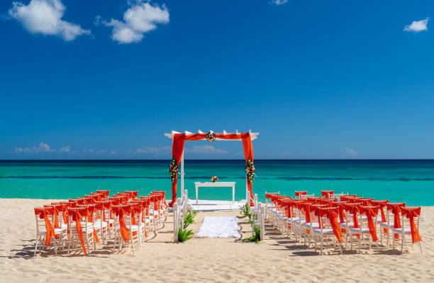 istock Romantic Wedding setting up with red decorations on the beach. 1395773645