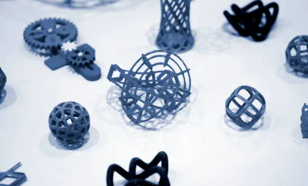 Photo of Many abstract models printed by 3d printer close-up.