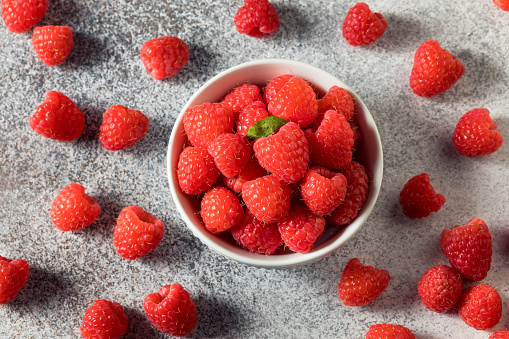 Raw Red Organic Raspberries in a Bowl