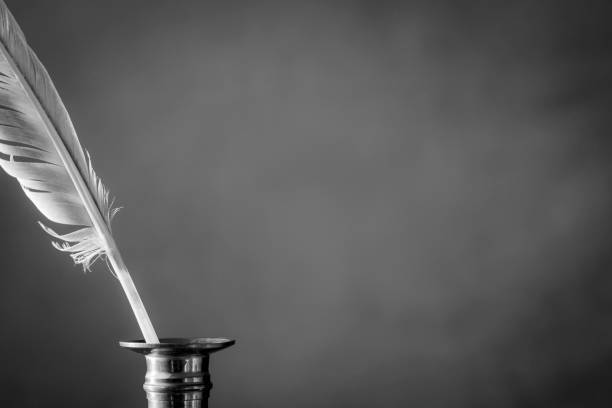 istock Quill pen and inkwell on a dark background. Vintage concept for additional text. Copy space. Black and white 1395778385