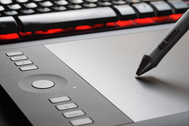 Graphic tablet with pen on the surface of device, close-up photo. Professional tool for illustrators, designers, retouchers.