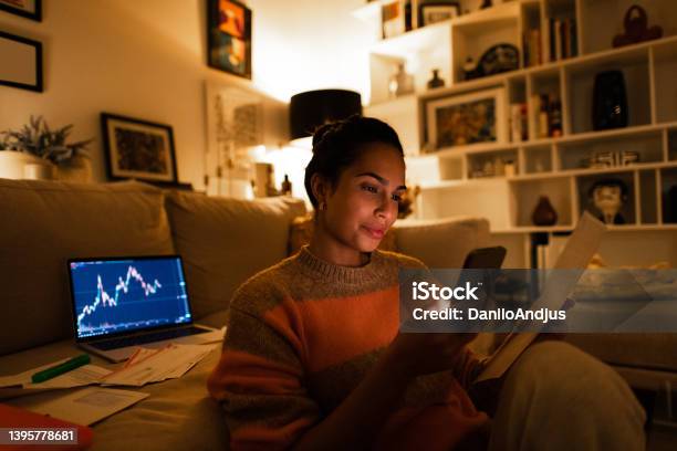 Beautiful Woman Trading Online Stock From Cozy Home At Night Stock Photo - Download Image Now