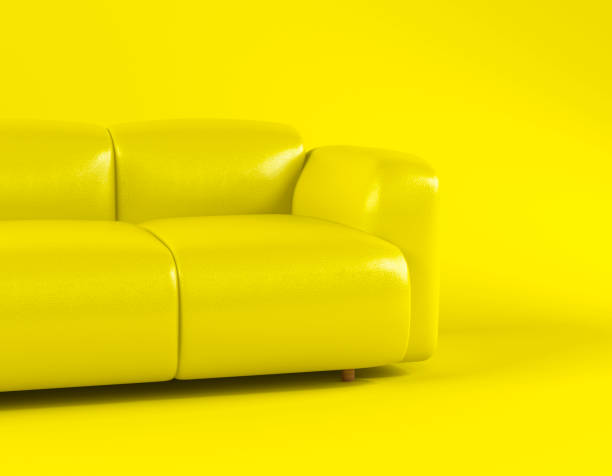 istock Yellow leather soft sofa on yellow background with shadow. Stylish cozy modern sofa made of genuine leather on wooden legs. Minimalistic interior room in yellow colors. Single piece of furniture 1395782879