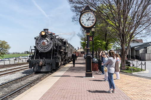 Strasburg, PA, USA - April 20,2022:  Passengers watch the Strasburg Railroad Train Pull into the Station