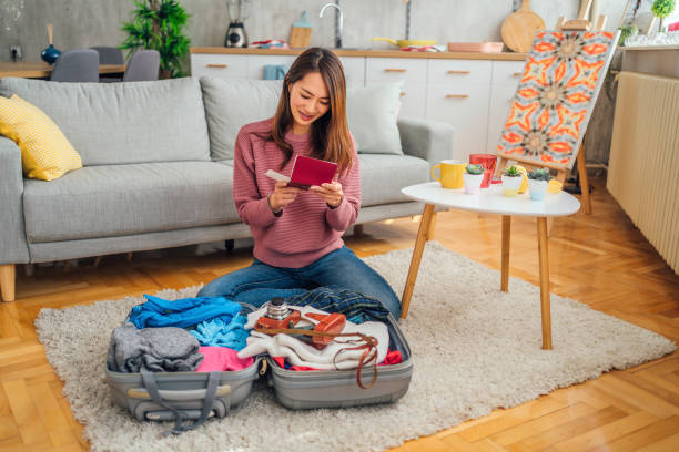 istock Woman packing her suitcase 1395783347