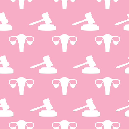 Vector seamless pattern of white gavels and uteruses on a pink square background.