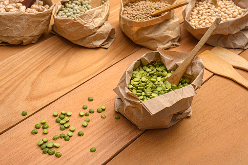 Close up view of green split peas in paper bag in the kitchen